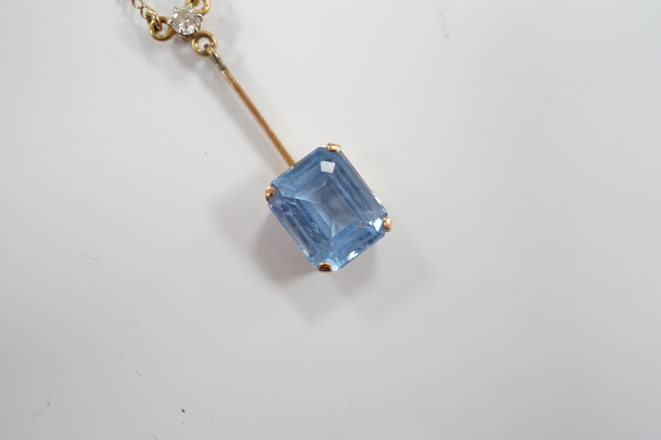 A 9c, single stone synthetic blue spinel and single stone diamond set drop pendant necklace, 44cm, gross weight 4 grams.